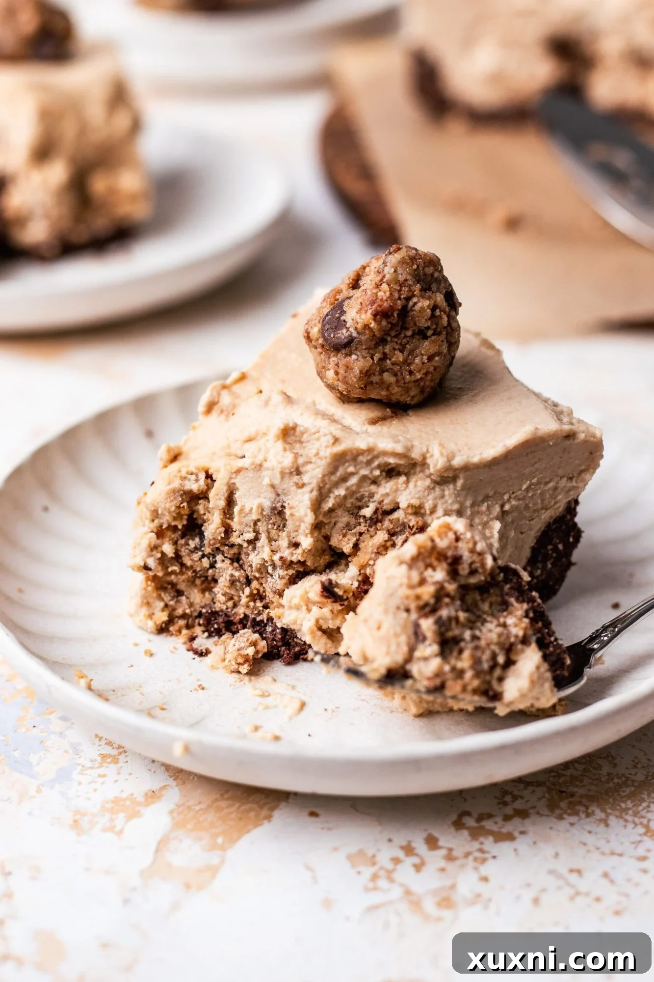 Slice of creamy cookie dough cheesecake with chocolate chips