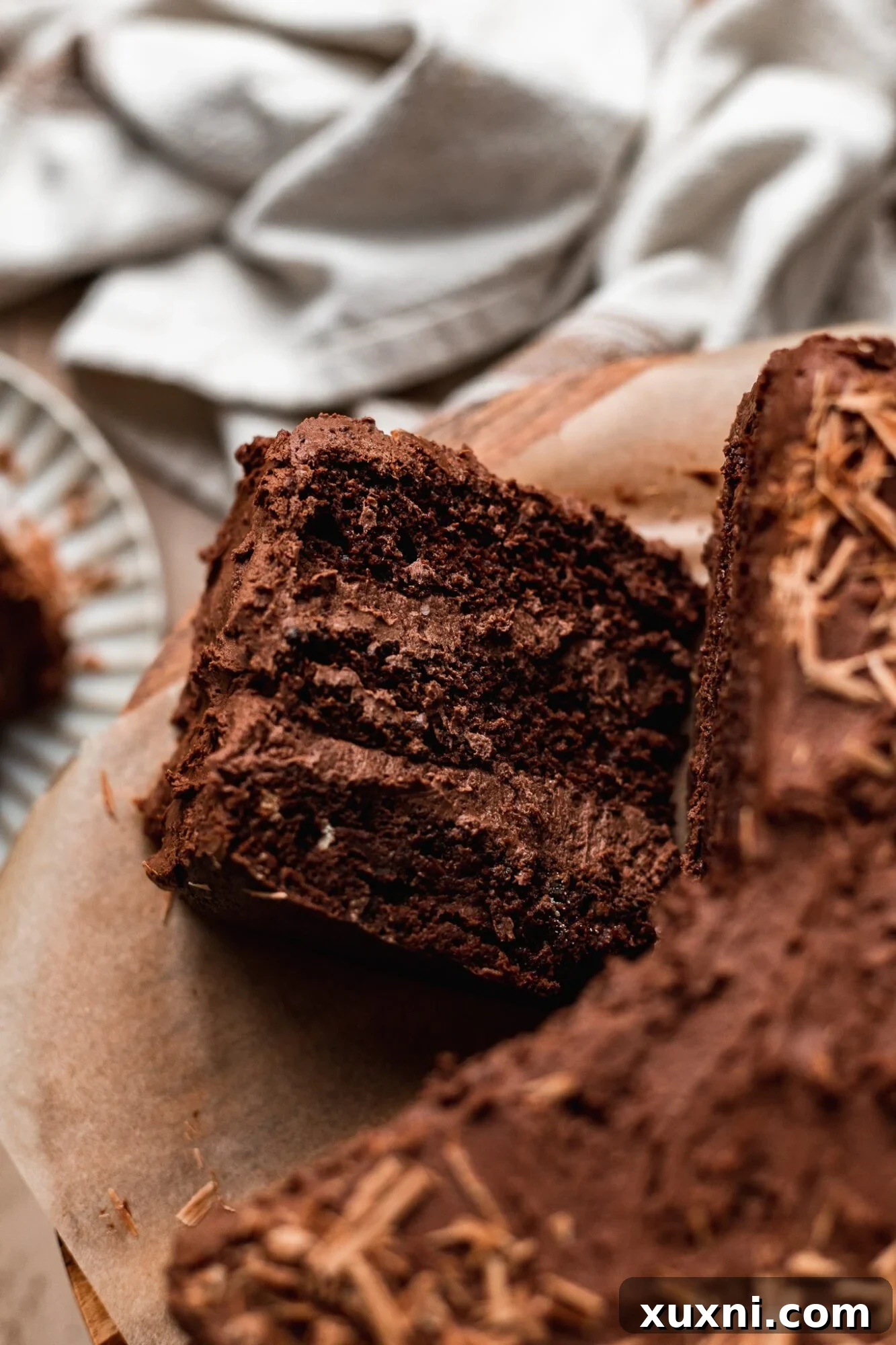 Irresistible Vegan Gluten-Free Chocolate Oat Cake 3 Slice of incredibly moist and rich vegan gluten-free chocolate cake with frosting.
