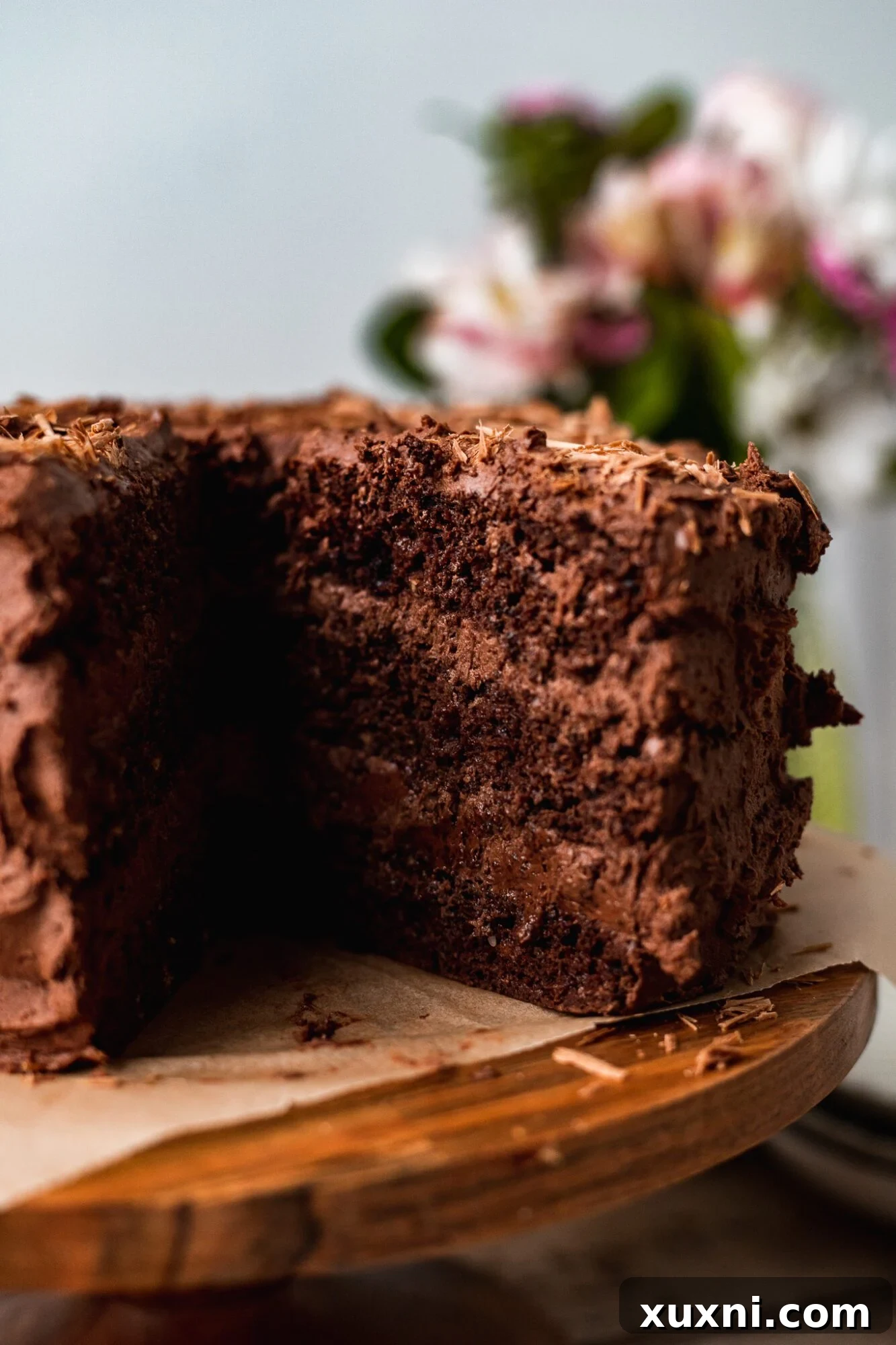 Irresistible Vegan Gluten-Free Chocolate Oat Cake 5 Close-up of a perfectly baked and frosted slice of gluten-free vegan chocolate cake.