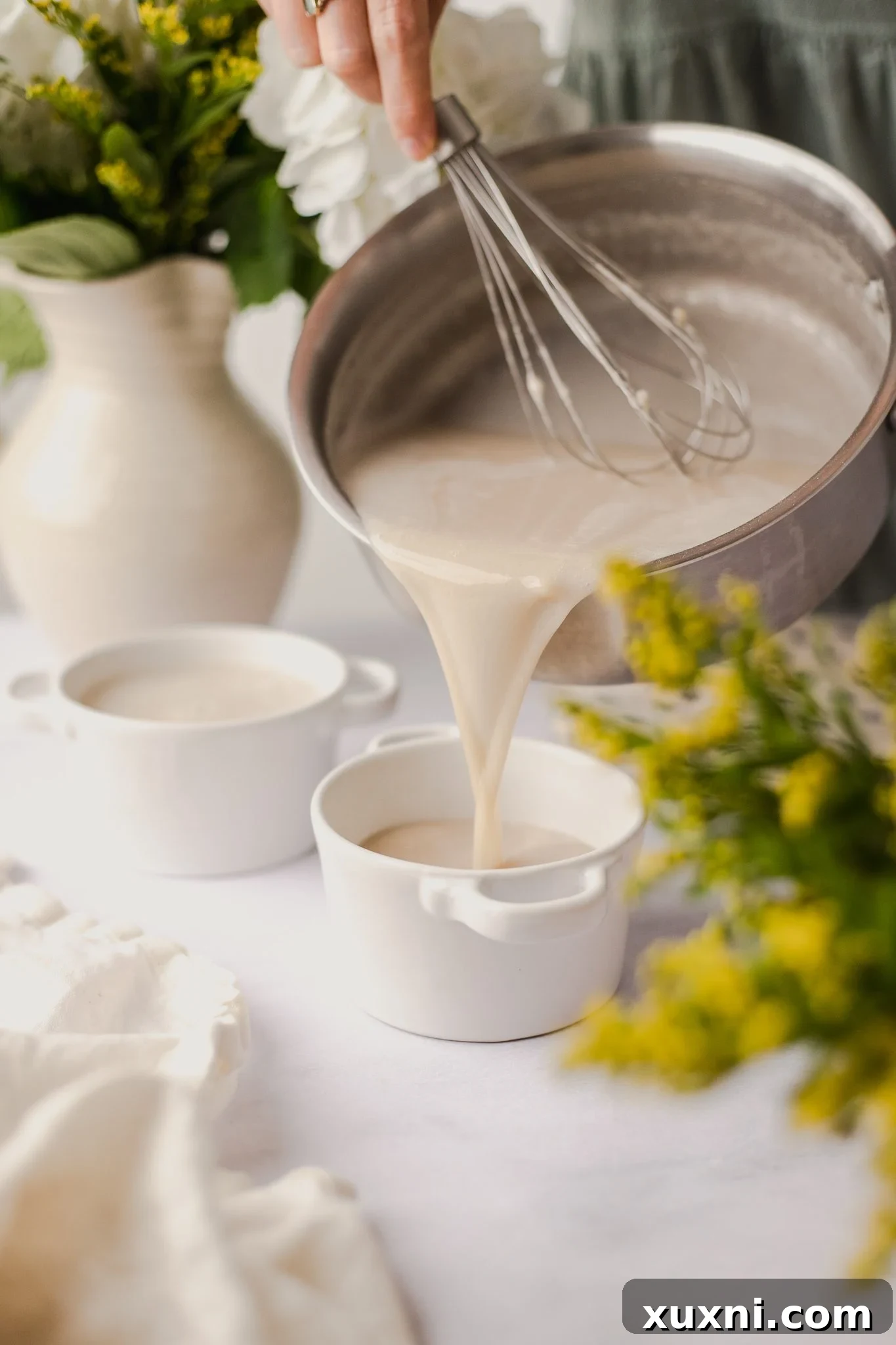 pouring Panna cotta into ramekins