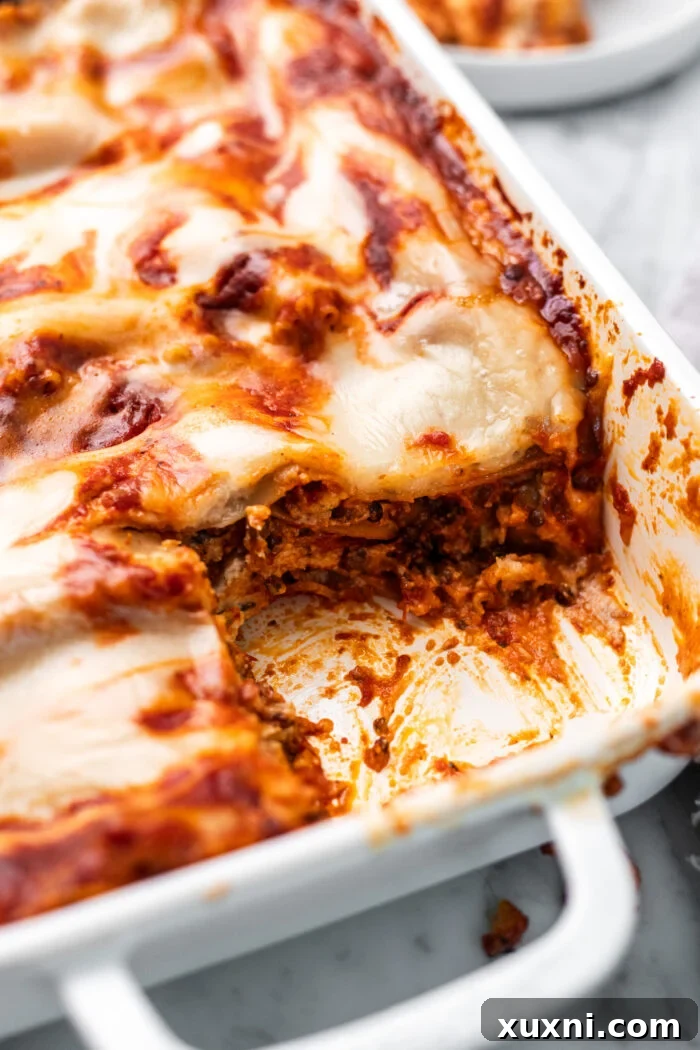 A close-up view of a perfectly sliced piece of vegan lasagna