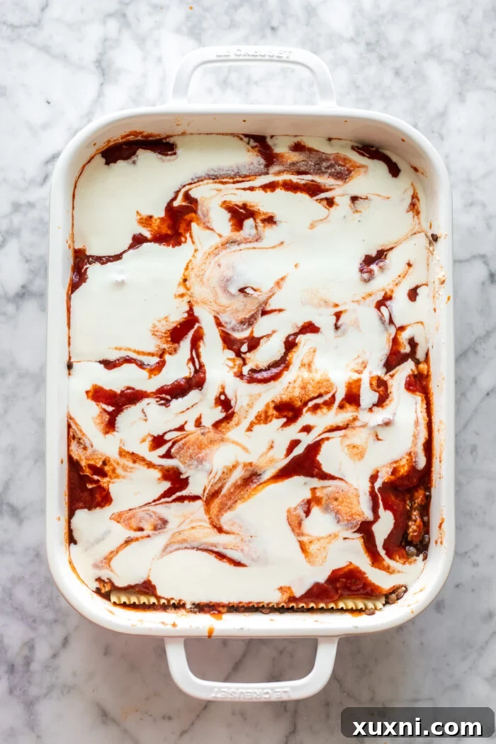 Unbaked vegan lasagna with all layers assembled