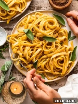 hand twirling pumpkin pasta