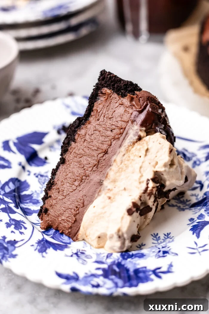 A perfect slice of no-bake vegan chocolate cheesecake with espresso whipped cream on a plate