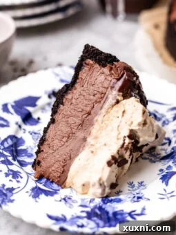 Slice of no-bake vegan chocolate cheesecake with espresso whipped cream on a plate for the recipe card