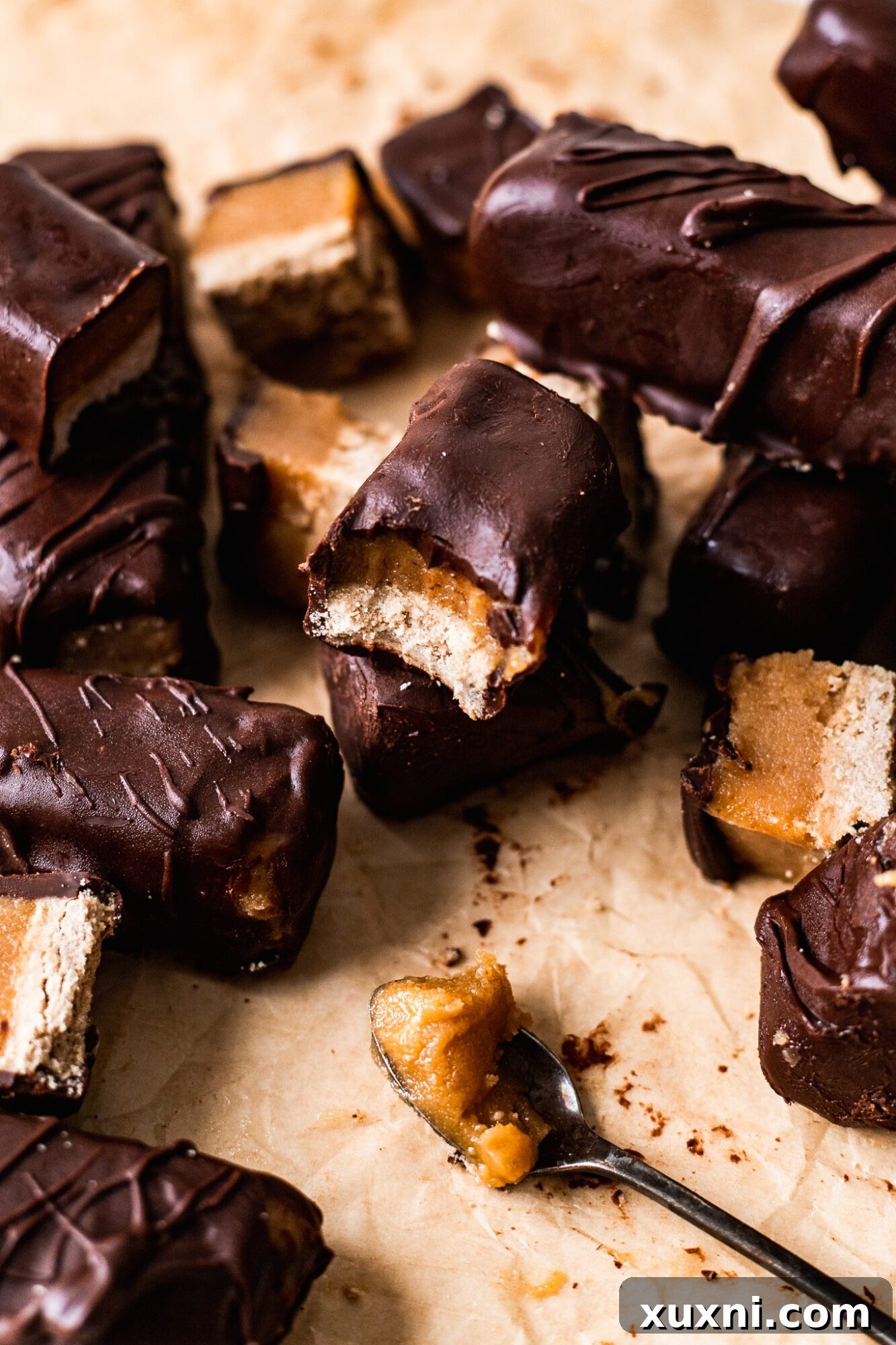 Close-up shot of homemade vegan Twix bars, showing the distinct layers.