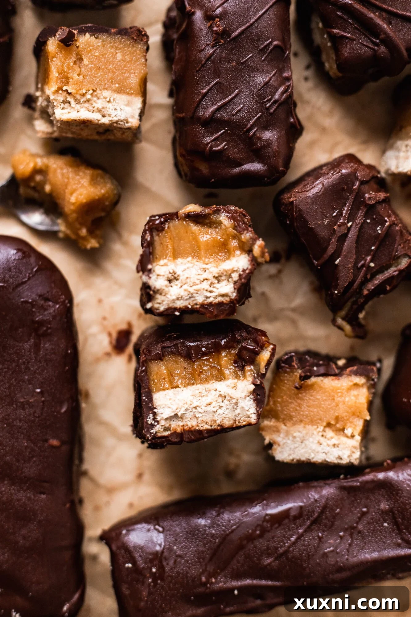 A close-up of a homemade vegan Twix bar being held, showing the texture.
