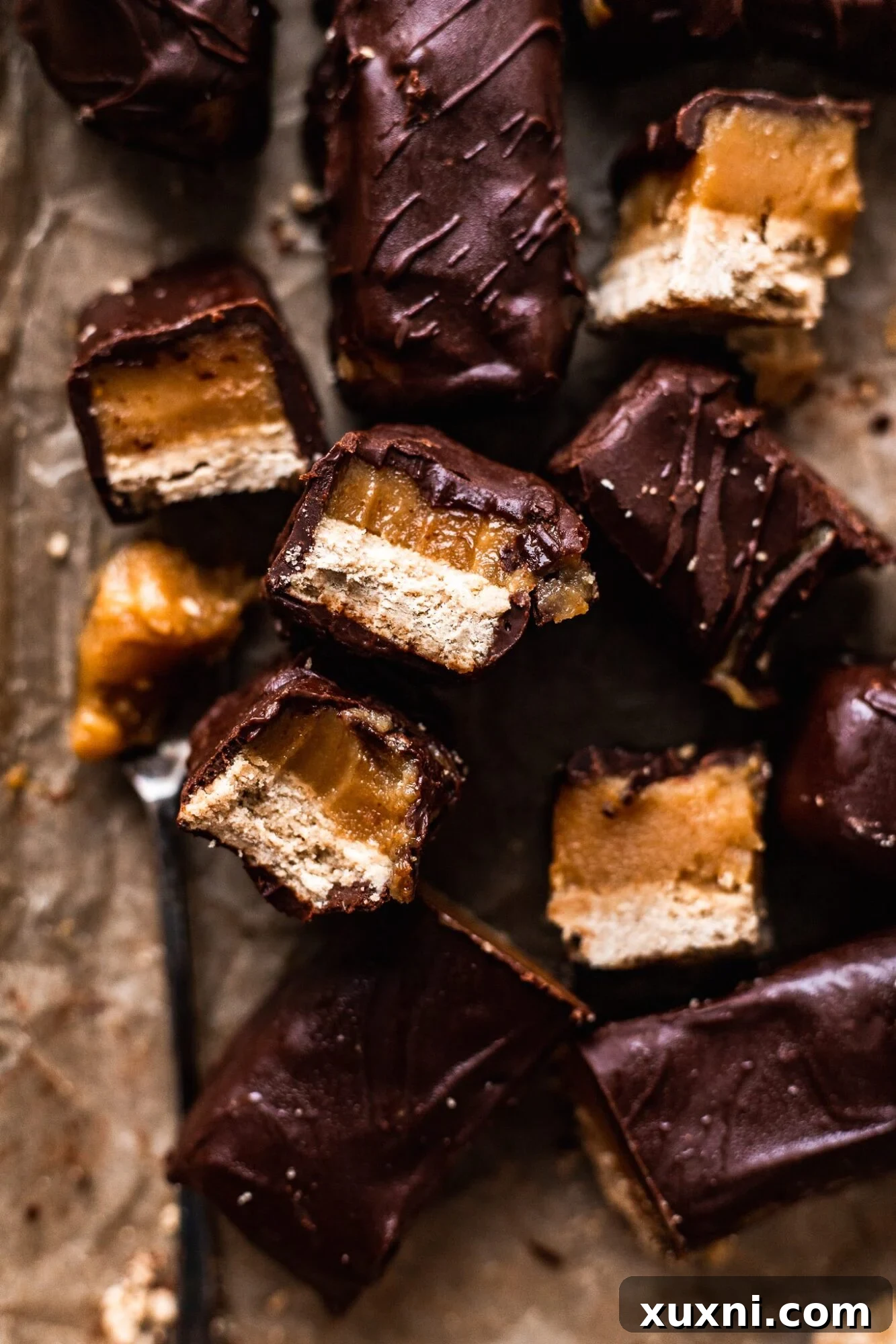 Several homemade vegan Twix bars stacked, showing their appetizing appearance.