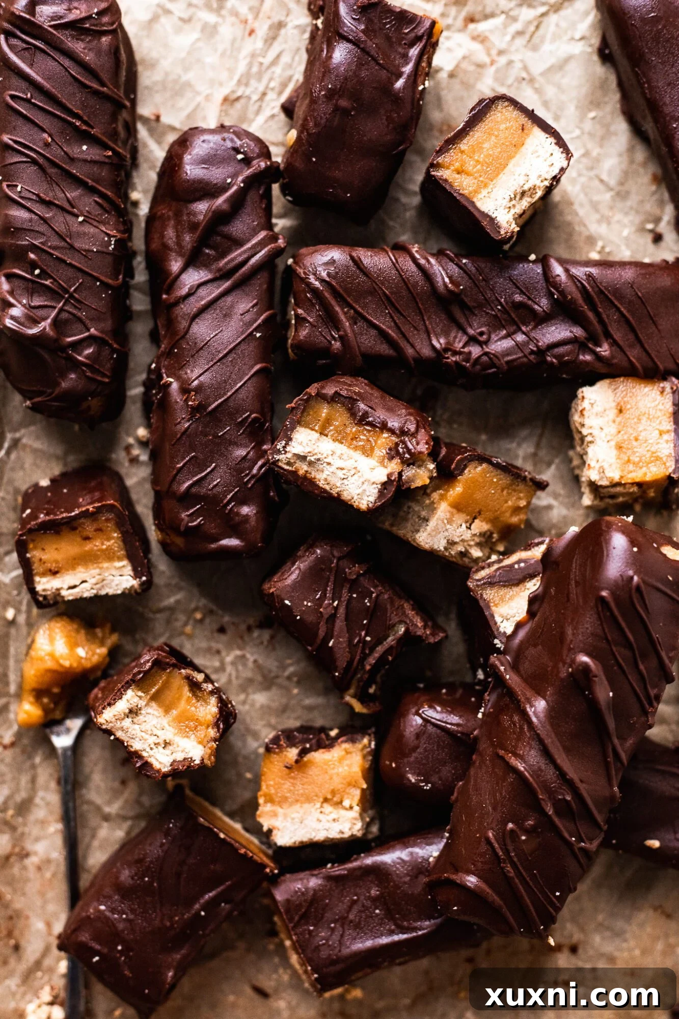 Close-up of a neatly sliced vegan Twix bar, showing its layers.
