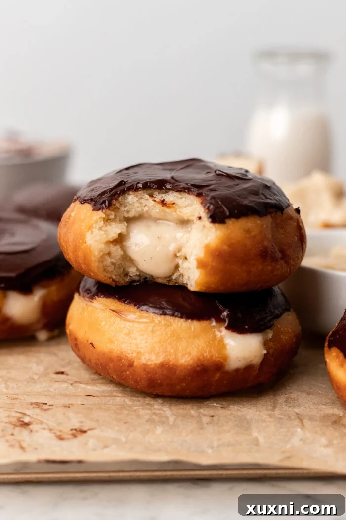 Decadent and Easy Vegan Boston Cream Doughnuts 2 stacked vegan Boston cream donuts