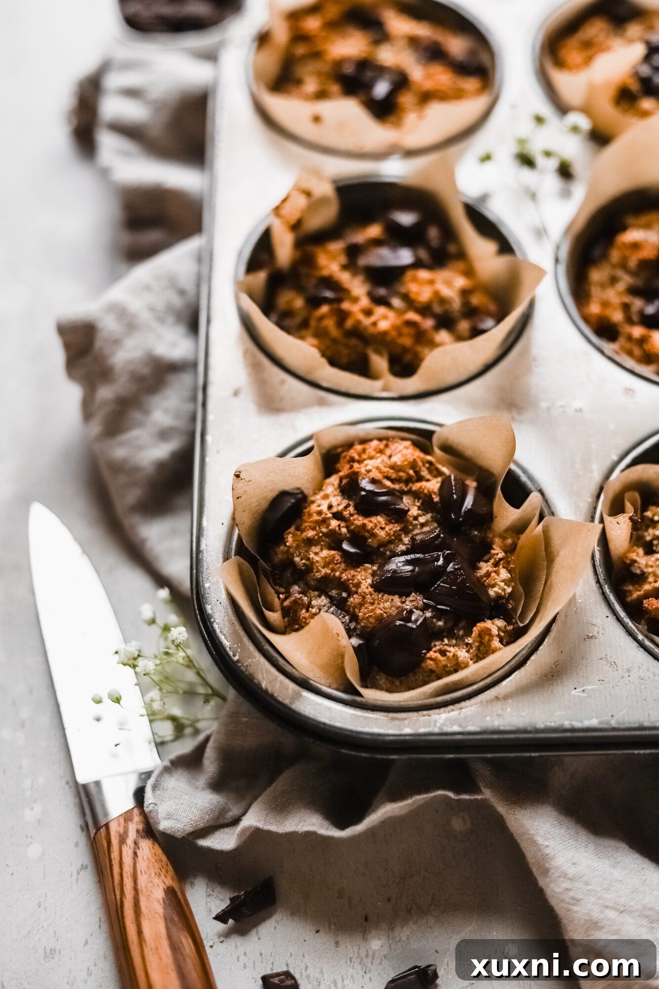 A delightful Paleo banana muffin nestled in a baking tin, perfect for any occasion.