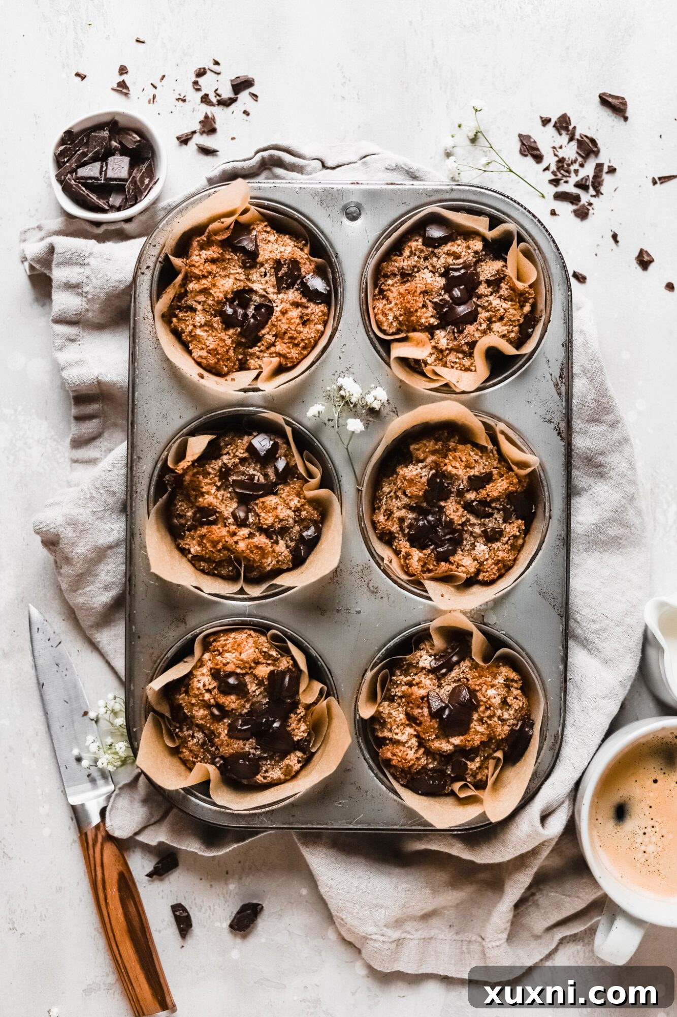 A tray of freshly baked vegan banana muffins cooling, showcasing their perfect dome tops.