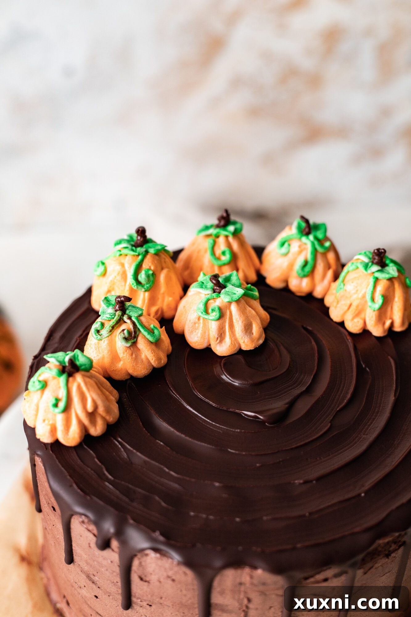 Close-up of decorative vegan buttercream pumpkins on cake