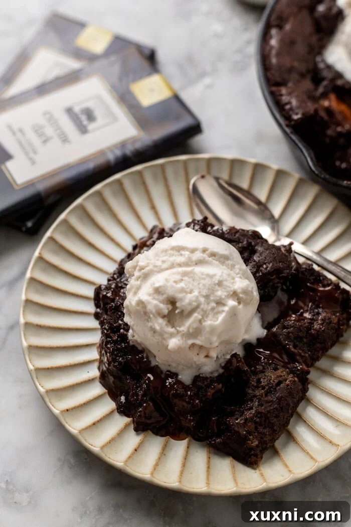 Slice of caramel cookie skillet on a plate with melted chocolate