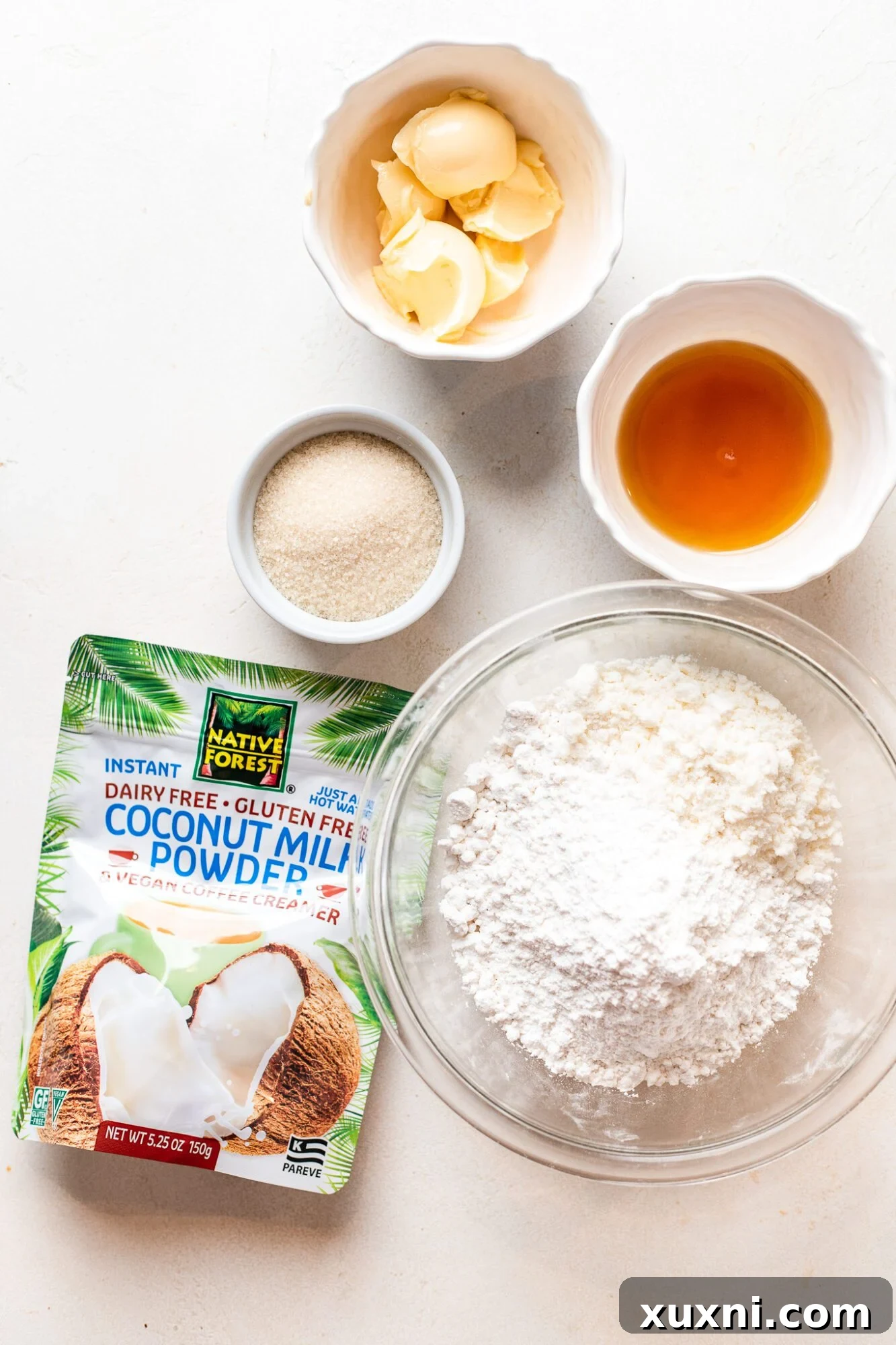 A selection of vegan candy corn ingredients including coconut milk powder, sugars, maple syrup, and vegan butter.