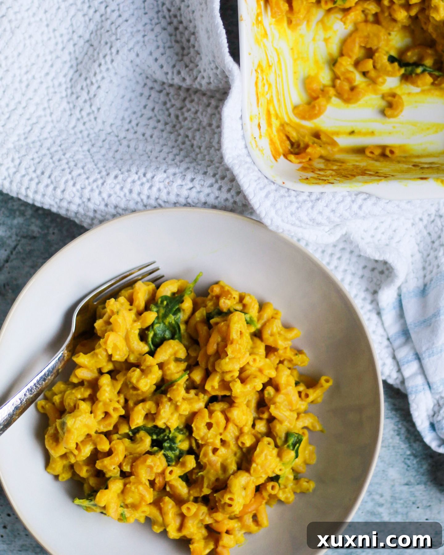 A generous serving of cauliflower vegan mac and cheese, showcasing its creamy texture and rich color.