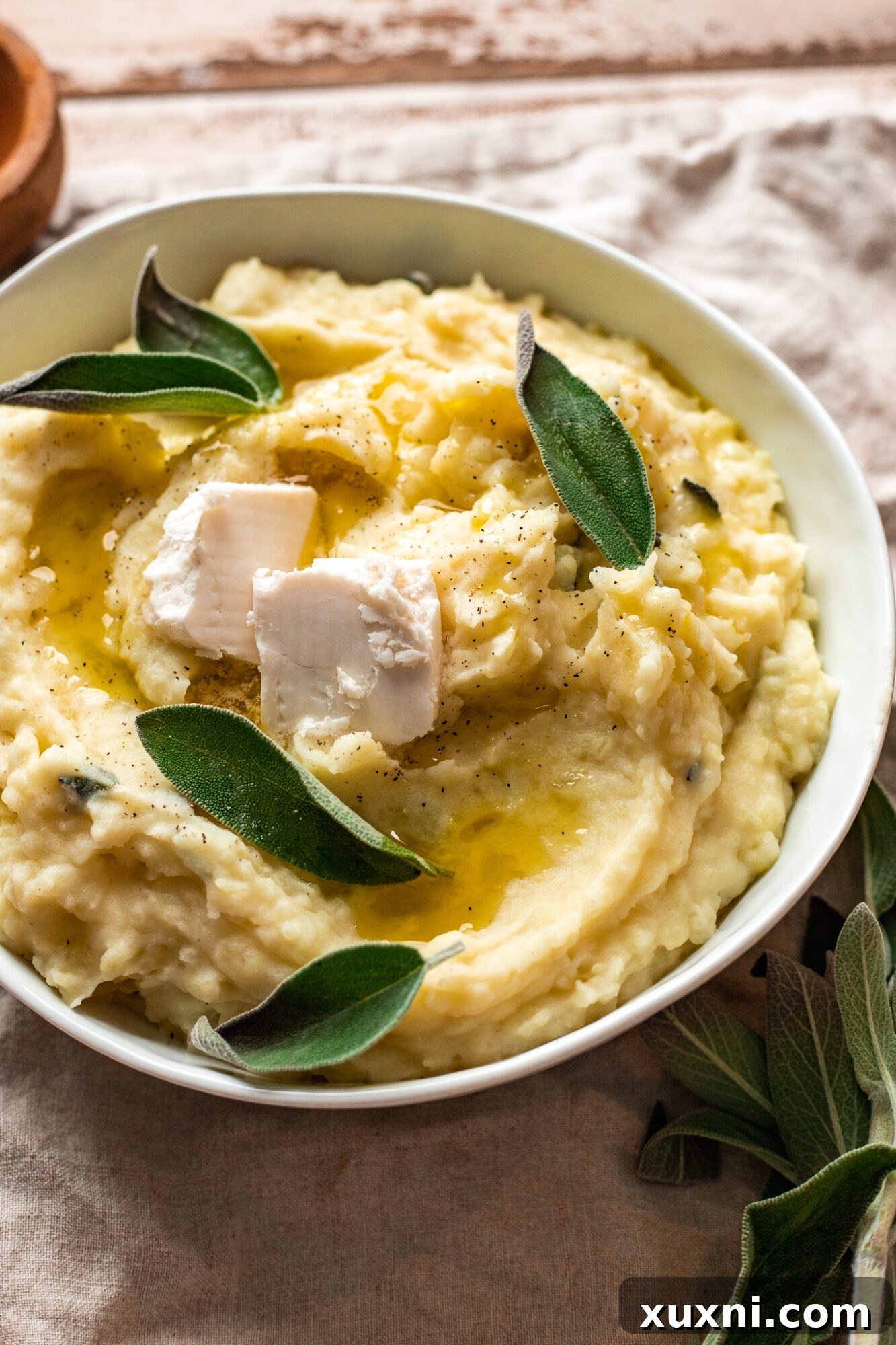 A bowl of super creamy and fluffy vegan mashed potatoes, ready to be served as a Thanksgiving side dish.