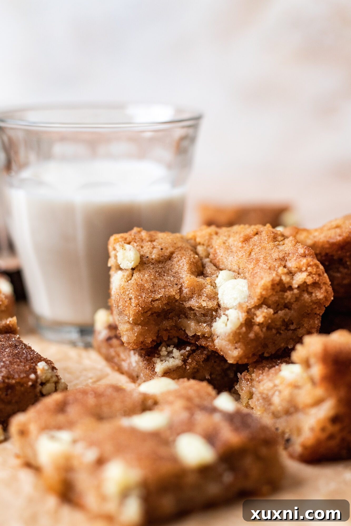 Stack of vegan snickerdoodle blondies with cinnamon sugar coating