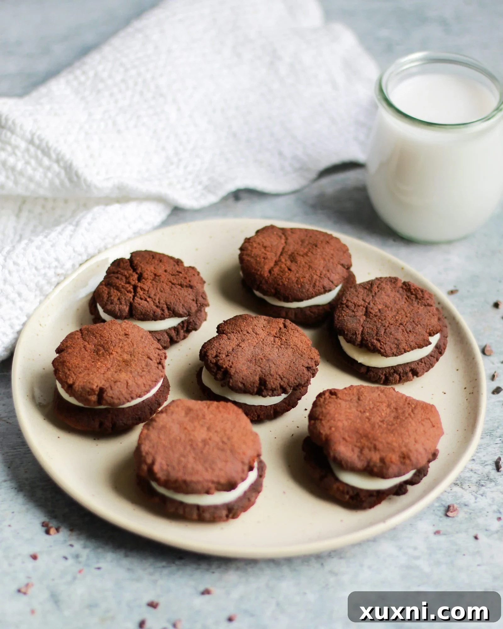 plate of paleo vegan oreos on a plate next to almond milk