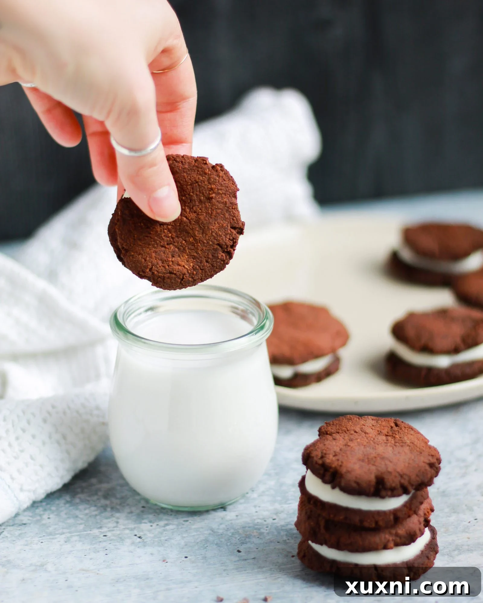dunking a paleo vegan Oreo into coconut milk