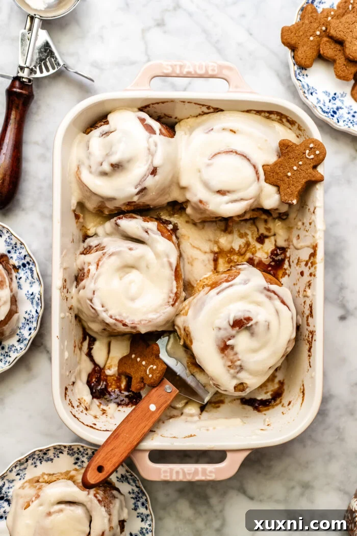 Soft and fluffy gingerbread cinnamon rolls served in a baking dish, ready to be enjoyed.