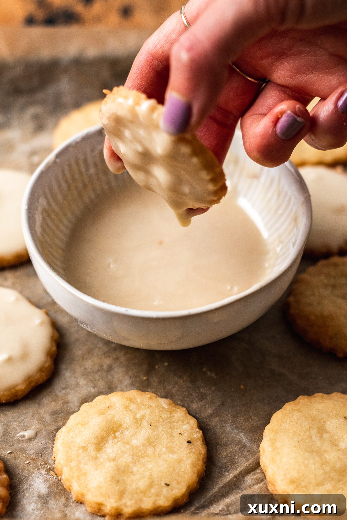 Close-up of decorated vegan Christmas shortbread with pink frosting