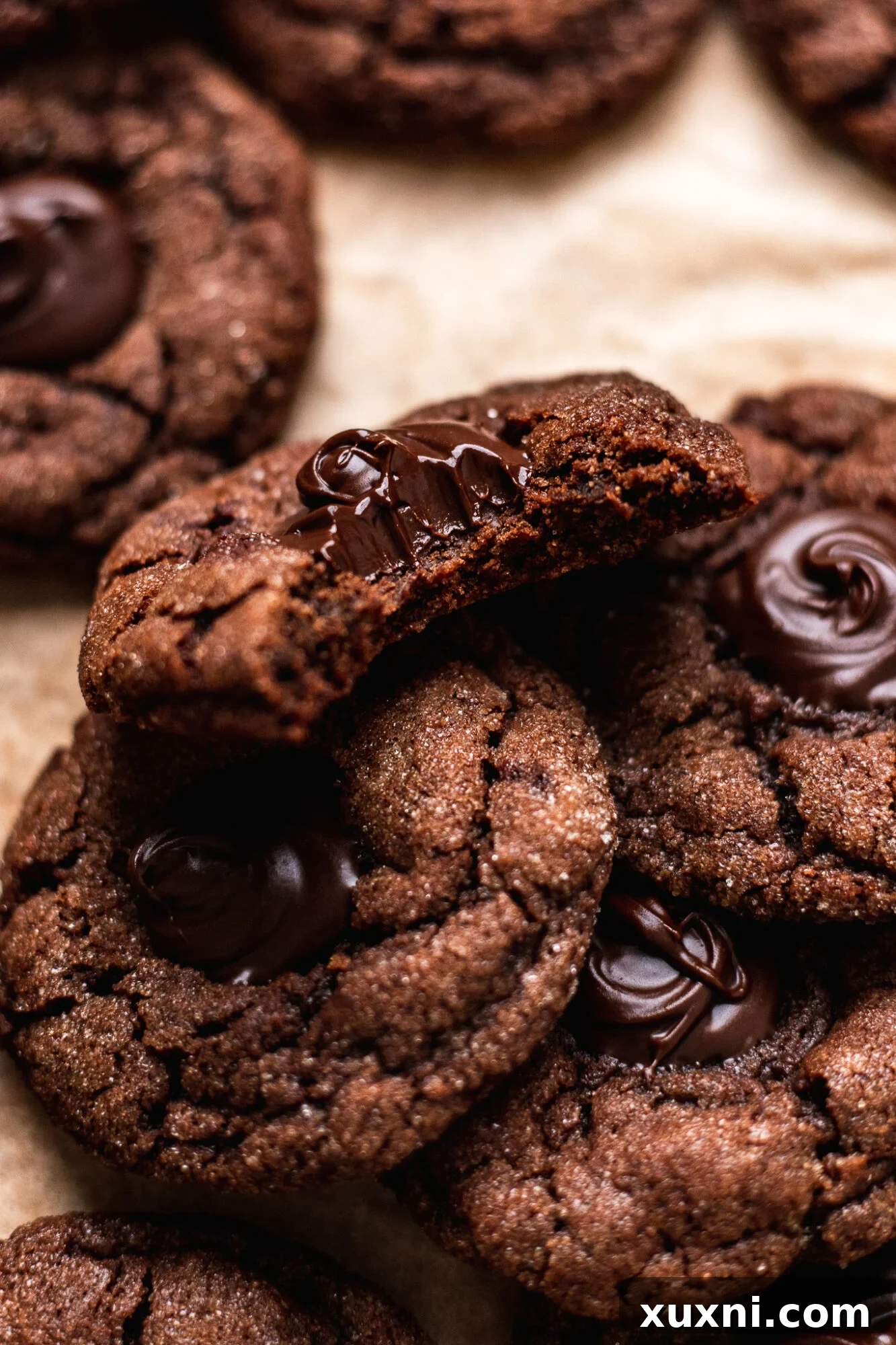 Bitten vegan chocolate thumbprint cookie revealing ganache filling