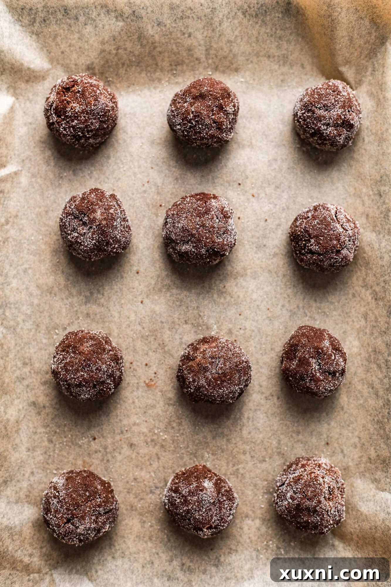 Rolling and sugaring cookie dough balls for thumbprint cookies