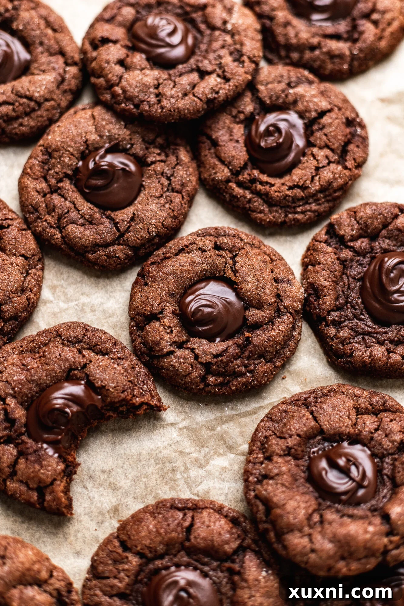 Close-up of baked vegan chocolate thumbprint cookies on a cooling rack