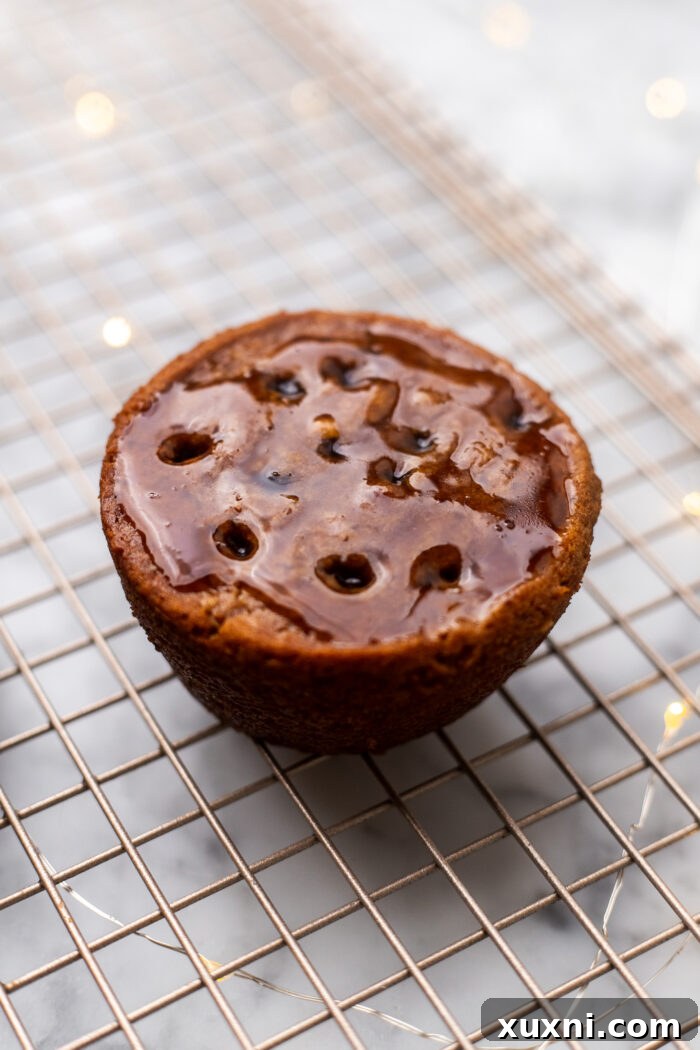 Simply Divine Vegan Sticky Toffee Pudding 11 Generously drizzling warm toffee sauce over the poked sticky toffee puddings on a cooling rack.