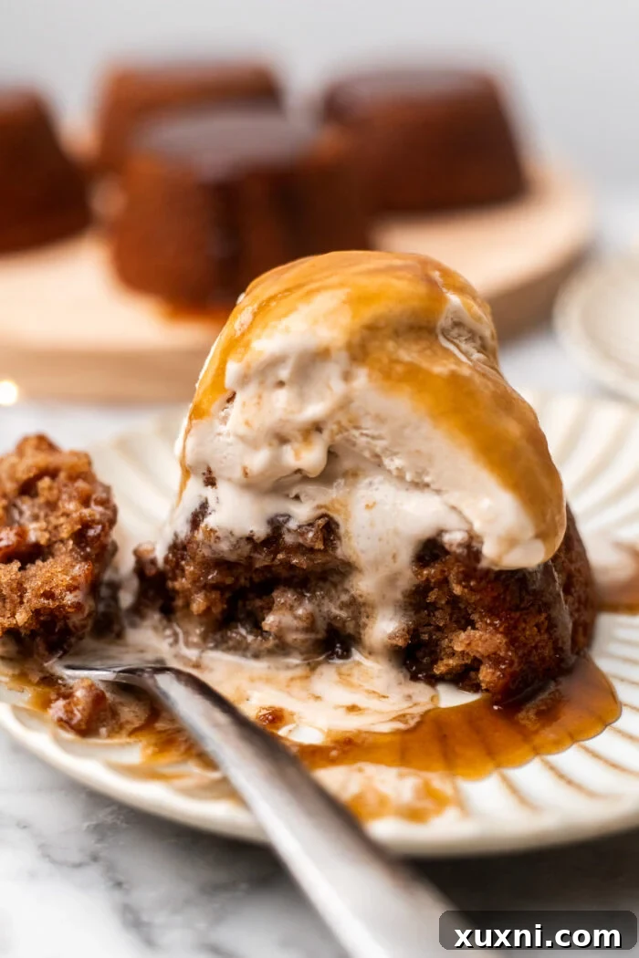 Simply Divine Vegan Sticky Toffee Pudding 13 A half-eaten vegan sticky toffee pudding, showing the moist interior and abundance of toffee sauce.