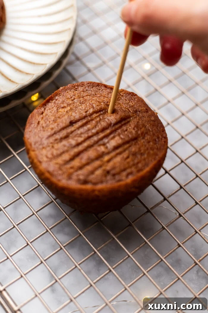 Simply Divine Vegan Sticky Toffee Pudding 10 Close-up of baked sticky toffee puddings with holes poked into them, ready to absorb more sauce.