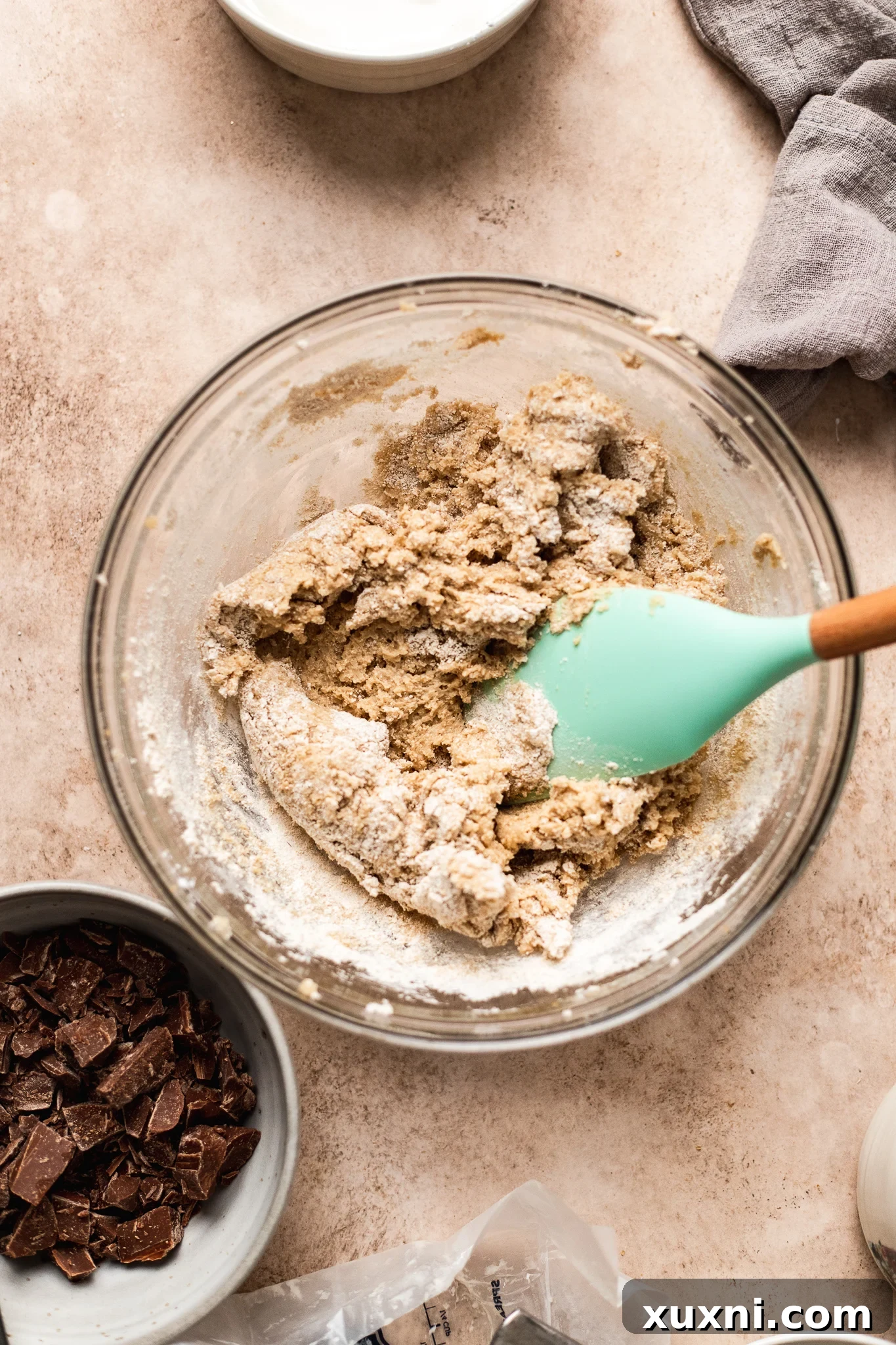 mixing oat flour into wet ingredients for chocolate chip cookies