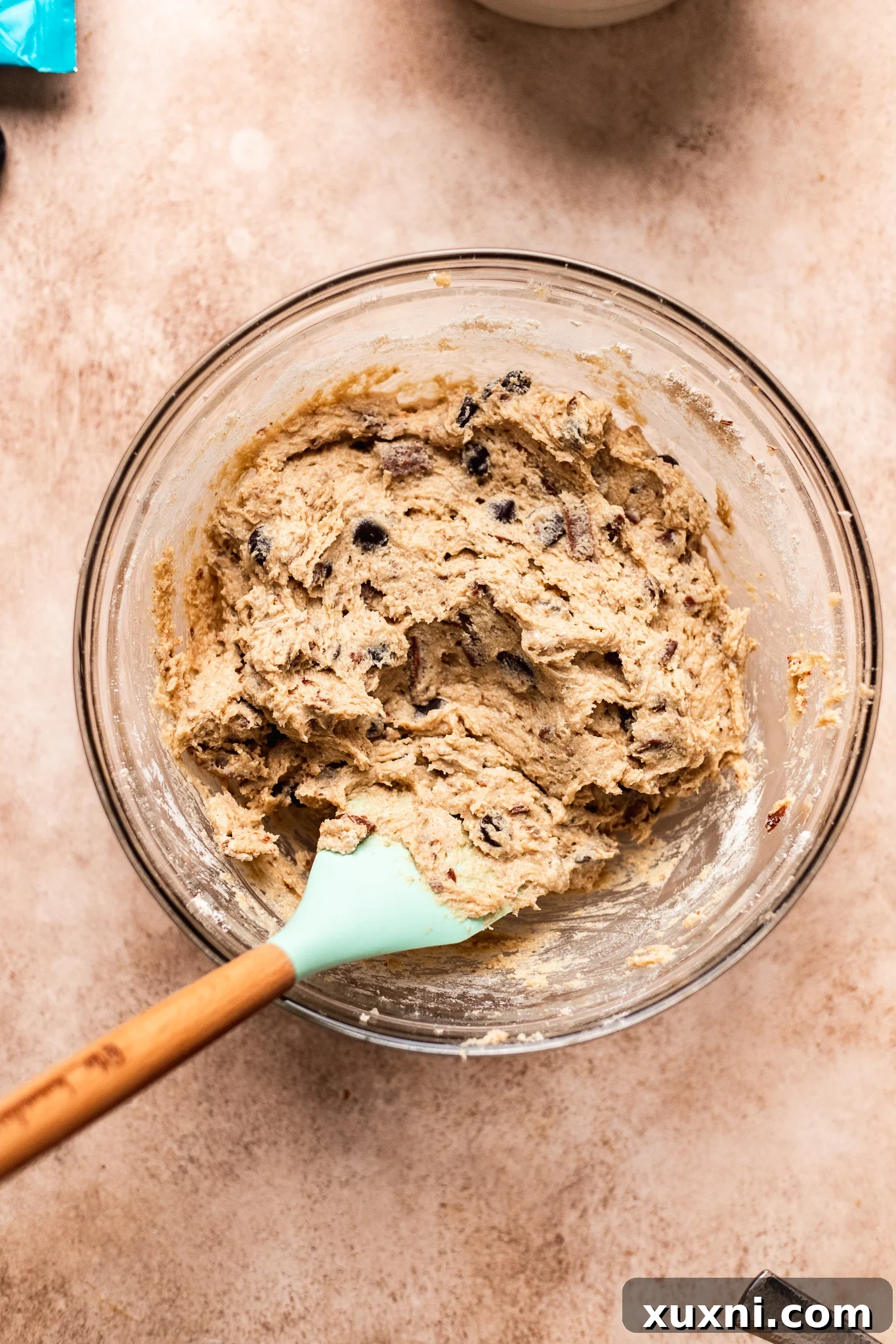 folding vegan chocolate chips into gluten free cookie dough