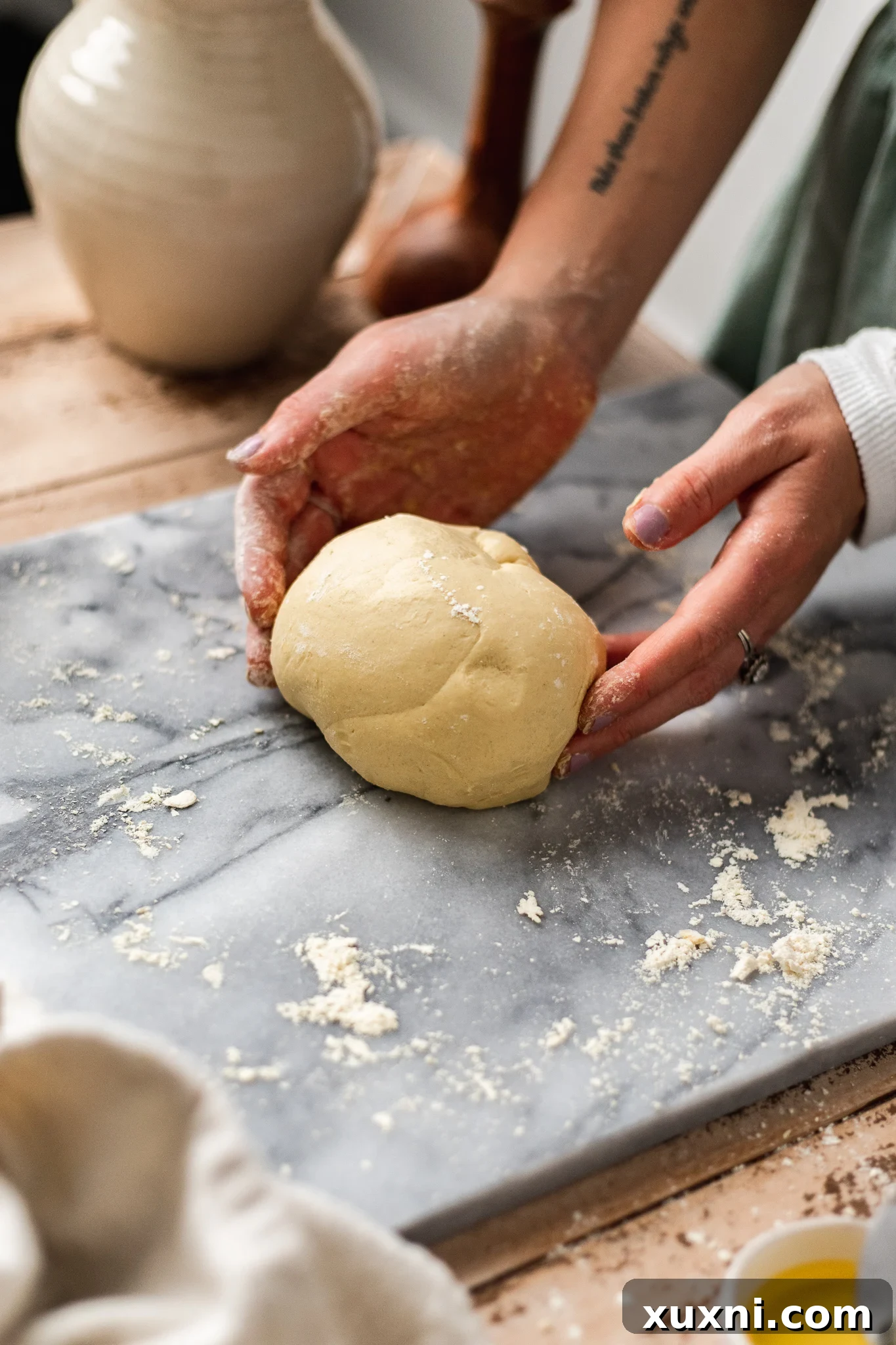 Kneading homemade vegan pasta dough until smooth and elastic.
