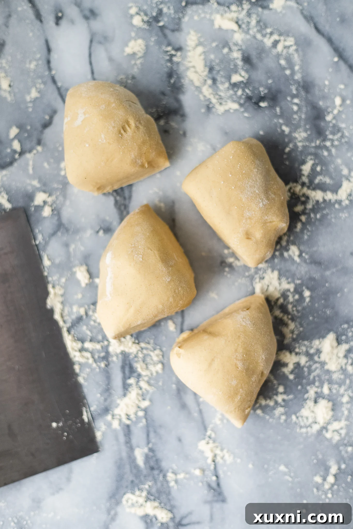 Dividing vegan pasta dough into sections for rolling.