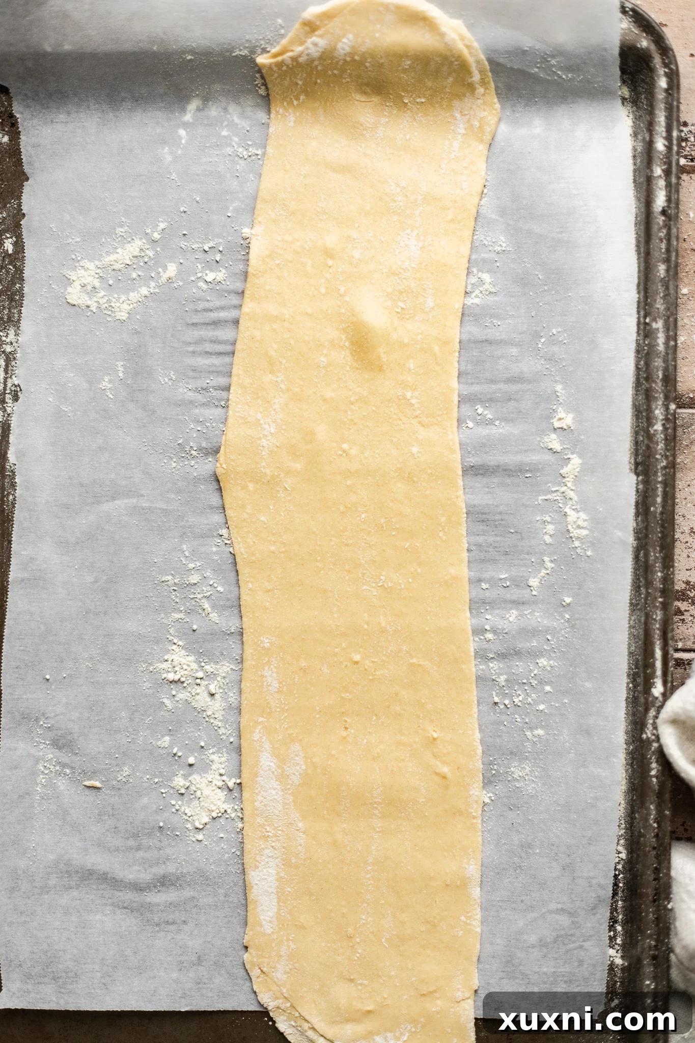 Freshly rolled pasta dough, ready to be cooked.