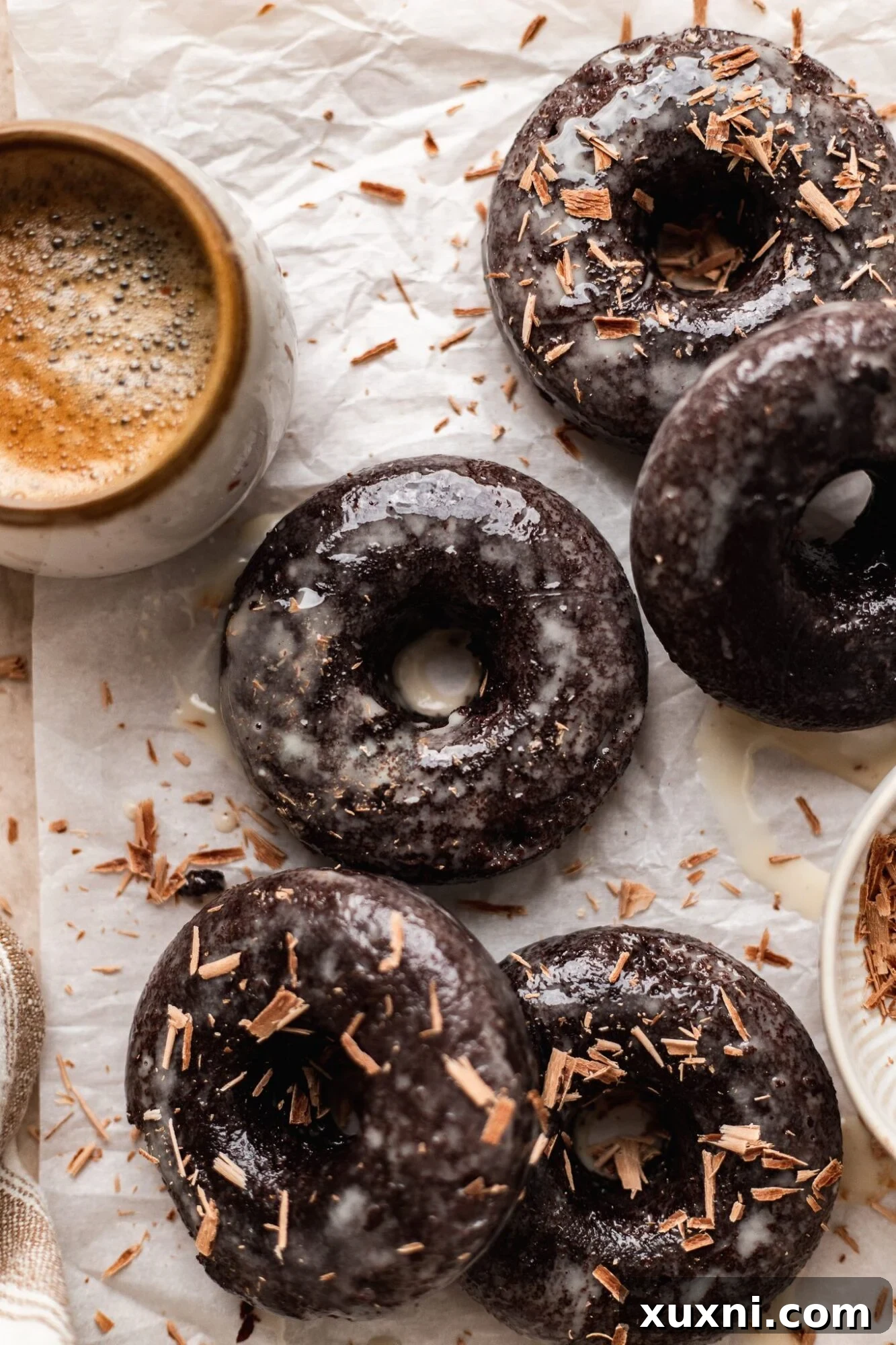 Indulgent Baked Vegan Chocolate Donuts with a shiny glaze, perfect for breakfast or dessert.