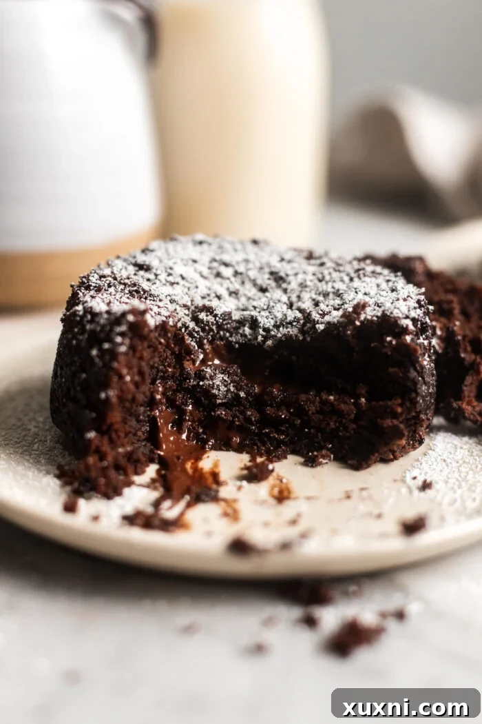 Beautifully presented vegan lava cake, topped with a scoop of vegan ice cream.
