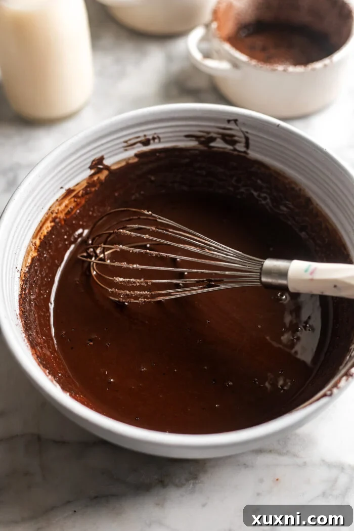 Melted vegan chocolate in a bowl, smooth and glossy.