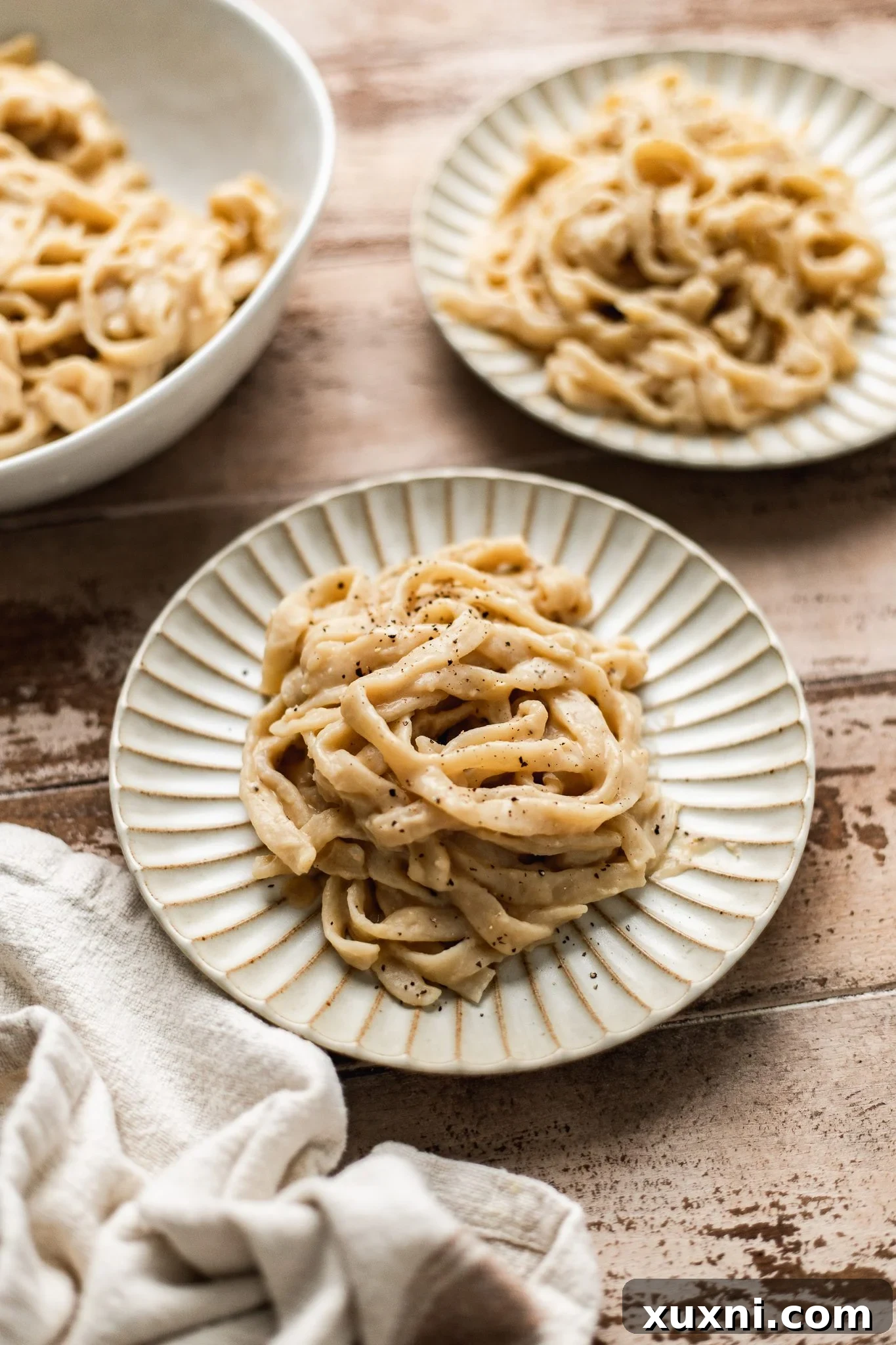 Unbelievably Creamy Nut-Free Vegan Cacio e Pepe 7 A perfectly plated serving of creamy vegan cacio e pepe, garnished with fresh black pepper and optional vegan parmesan.