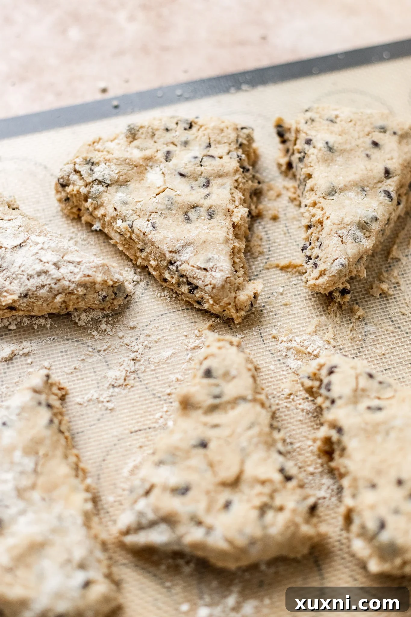 Ultimate Vegan Gluten-Free Chocolate Chip Scones 9 Sliced vegan chocolate chip scones on parchment paper