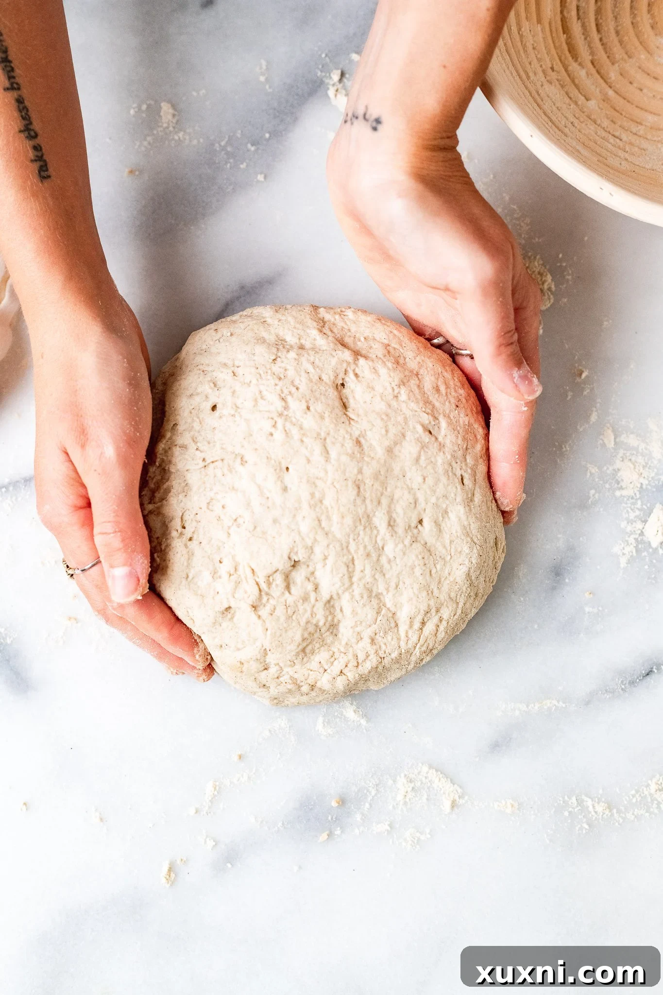 Smooth, round gluten-free vegan dough ball formed after the second knead, ready for the proofing basket.