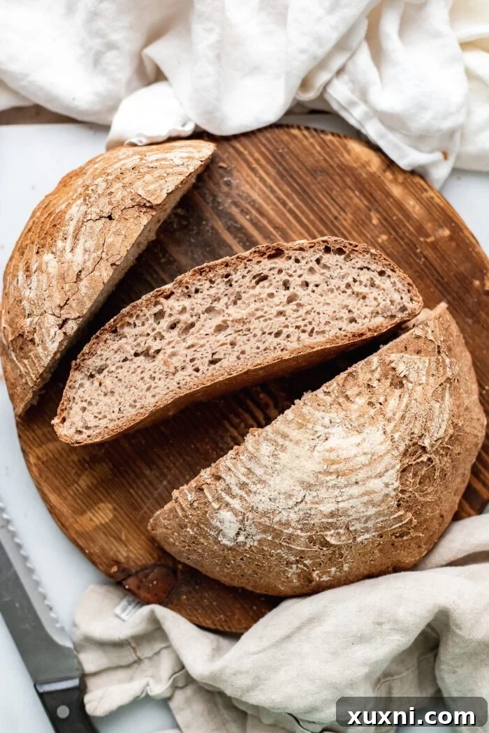 Beautifully sliced gluten-free artisan bread presented on a wooden cutting board, ready to be served.