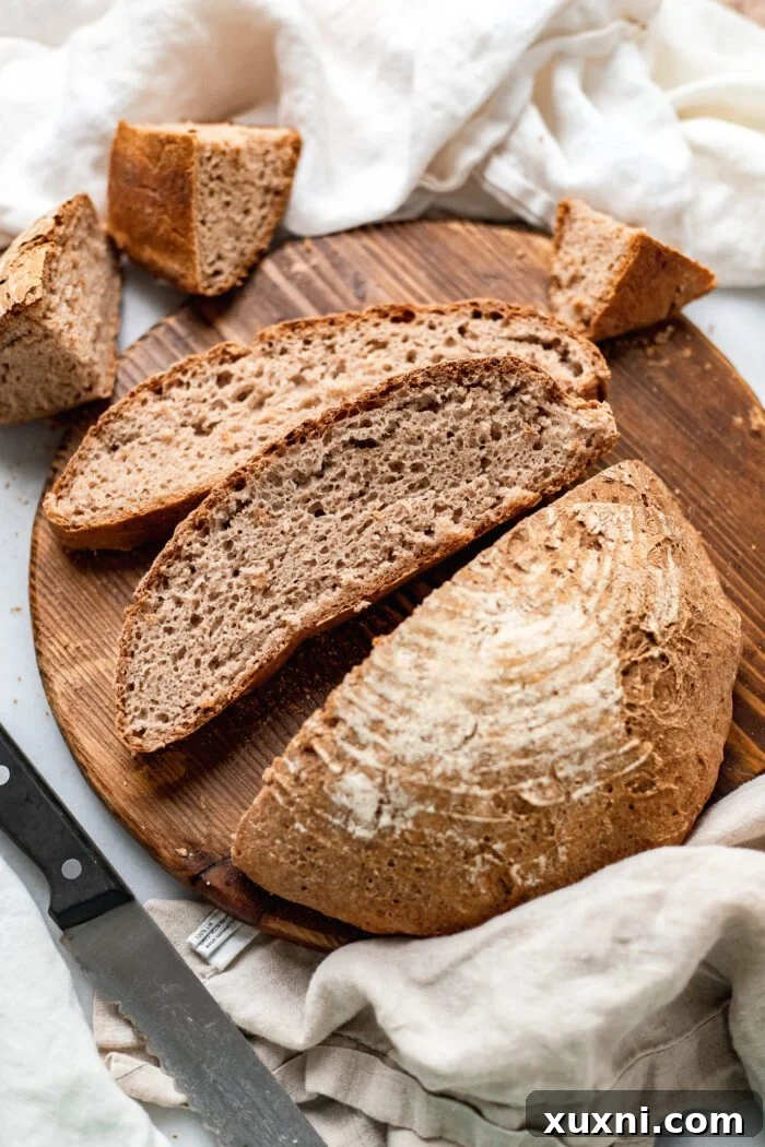 An array of perfectly sliced gluten-free vegan artisan bread on a wooden cutting board, with a focus on its appealing texture.