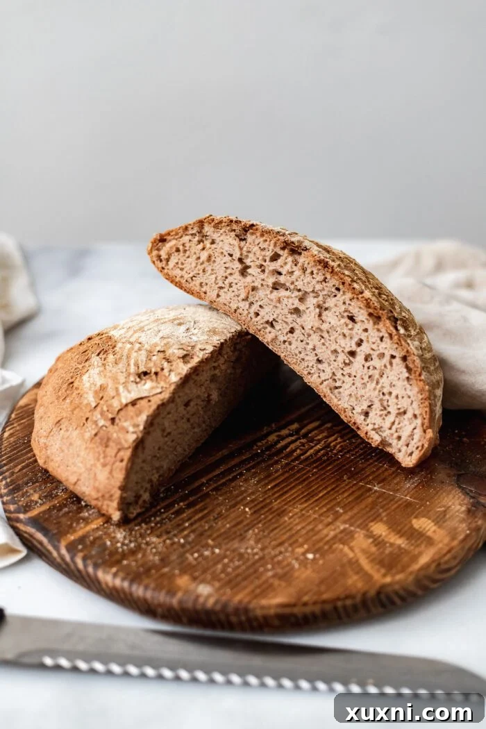 A close-up shot of a perfectly sliced open gluten-free vegan bread, highlighting its internal texture and golden crust.