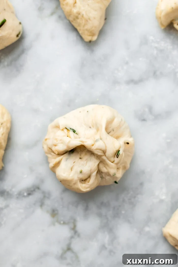 pinching the edges of the dough to seal the cheese filling