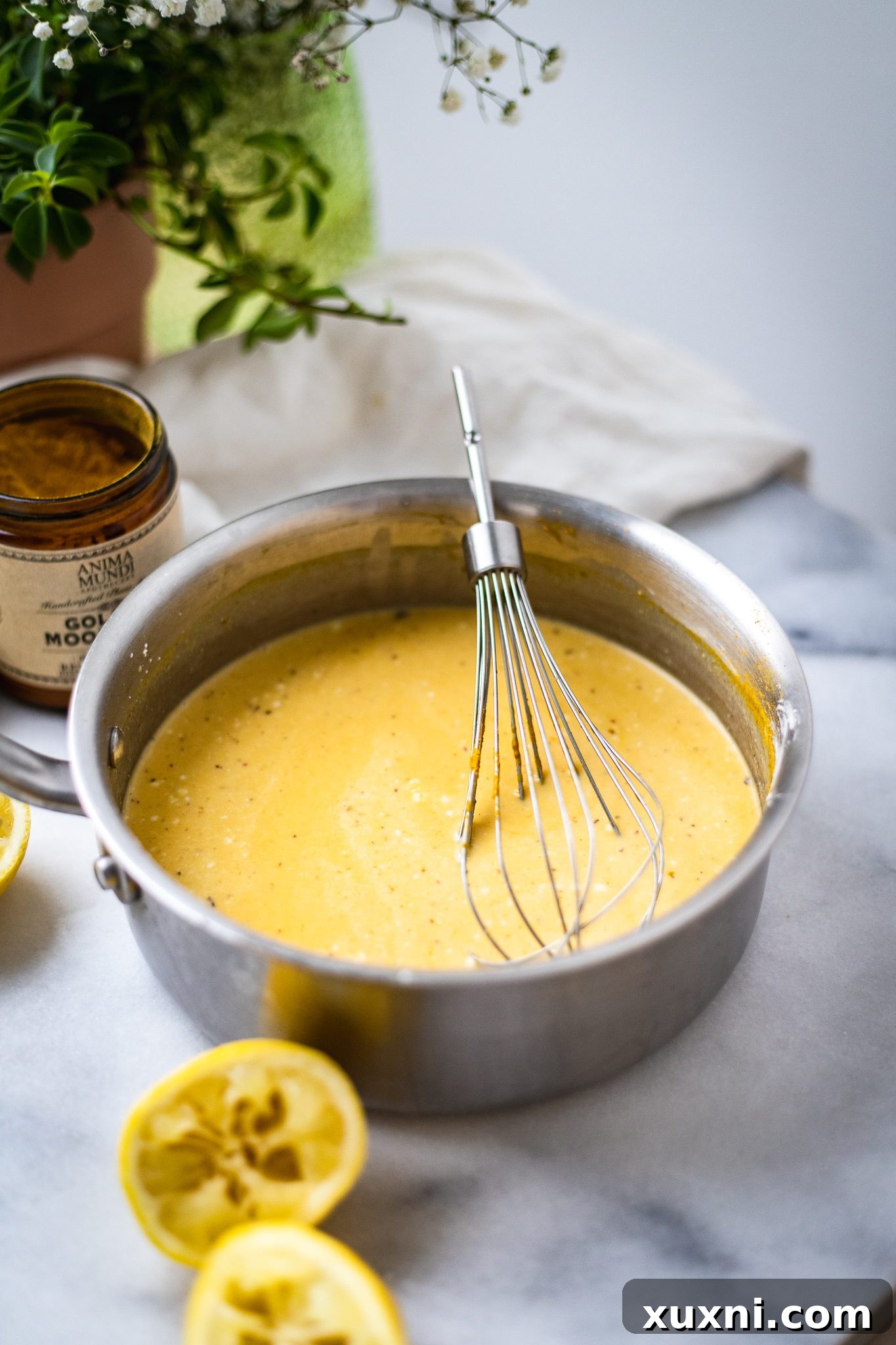 Ingredients for vegan lemon custard being mixed in a saucepan, prior to heating.