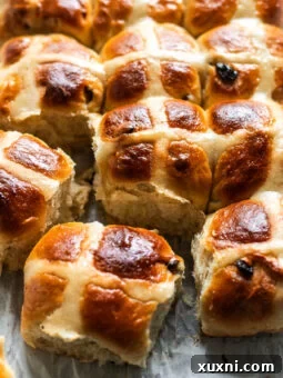 vegan hot cross buns on parchment paper