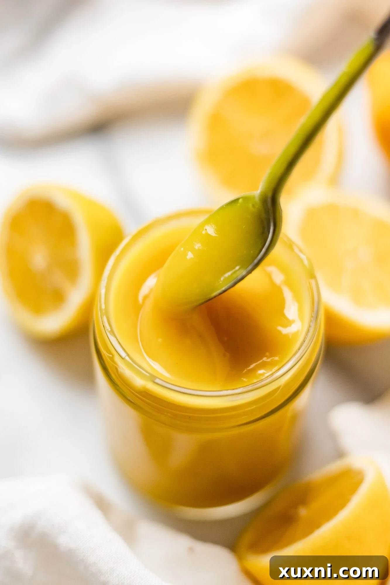 spoon scooping up lemon curd